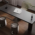 Modern Black Desk with Laptop Table Lamp Vase Plant and Wicker Stools