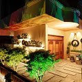 Detached Villa With Wooden Door Courtyard Green Plants And Decorative Lighting