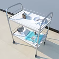 Two Tier Medical Trolley With Wheels Holding Medical Supplies And Instruments
