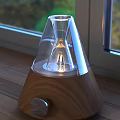 Modern Electronic Table Lamp With Transparent Glass Shade Wooden Base On Wooden Table By Window