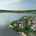 Aerial Planning for Waterfront Residential Community Featuring Lake Boats and Lush Greenery