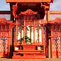 Traditional Chinese Red Garden Ornament With Carved Pavilion Structure And Green Plants