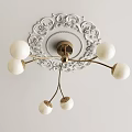 Modern Chandelier with White Spherical Shades and Golden Metal Arms Mounted on Ornate Ceiling Plate