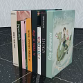 Row of Books with Pet Lifestyle Titles and Polly Dunbar Children's Story on Textured Wall