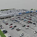 Aerial View of Large Retail Store Parking Lot Full of Cars and Green Surroundings
