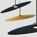 Modern Blue and Yellow Disc Shaped Pendant Lights Illuminated in Interior with Soft Glow