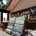 Traditional Fabric Store With Wooden Shelves Hanging Clothes And Stacked Blue White Patterned Fabrics