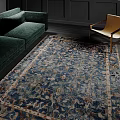 Blue Floral Pattern Square Rug In Living Room With Green Sofa And Chair