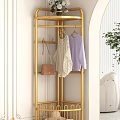 Elegant Golden Clothes Rack with Hooks Holding Clothes and Handbag in Modern Interior
