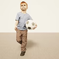 Young Boy Walking With Soccer Ball In Casual Outfit