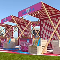 Vibrant Event Entrance Featuring Red And White Checkered Tents On Grass With Pink Flower Decorations