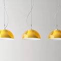 Three Golden Dome Shaped Pendant Lights Hanging in Modern White Interior