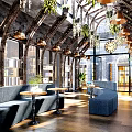 Book Art Interior Design Featuring Arched Metal Roof Green Plants Bookshelves And Blue Seating