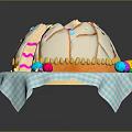 Round Dome Shaped Cake With White Frosting And Colorful Decorations On Blue White Checkered Napkin