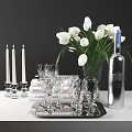 Silver Wine Bottle And Clear Glasses On Stylish Table With White Tulips Candles And Books