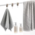 Gray Towels Arrangement In Bathroom With Toiletries And Decorative Items