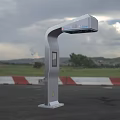 Outdoor Silver Smart Device With Display Screen In Open Field And Mountain View