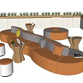 Modern Curved Public Seating With Orange Gray Cushions Small Round Tables And Plants