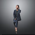 Cute Child in Navy Blue Suit and Grey Top Sitting on Dark Background Touching Ear