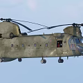 Military Green Twin Rotor Helicopter Flying In Blue Sky With Rotor Blades
