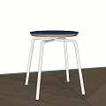 Modern Minimalist Stool With Blue Round Seat And Silver Metal Cross Legs On Wooden Floor