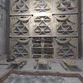 Large Geometric Patterned Shelves In Stone Wall Room With Gold Accents Benches And Rug