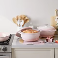 Pink Cookware Collection With Lidded Pots Wooden Utensils And Baking Pastry Bread