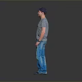 Man Wearing Striped T-Shirt And Blue Jeans With Cap Standing Against Gray Background