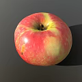 Juicy Fresh Ripe Red Apple With Yellow Streaks Speckled Surface On Gray Background