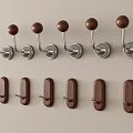Decorative Wall Hooks with Metal Balls and Wooden Rectangular Shapes Mounted on Light Colored Wall
