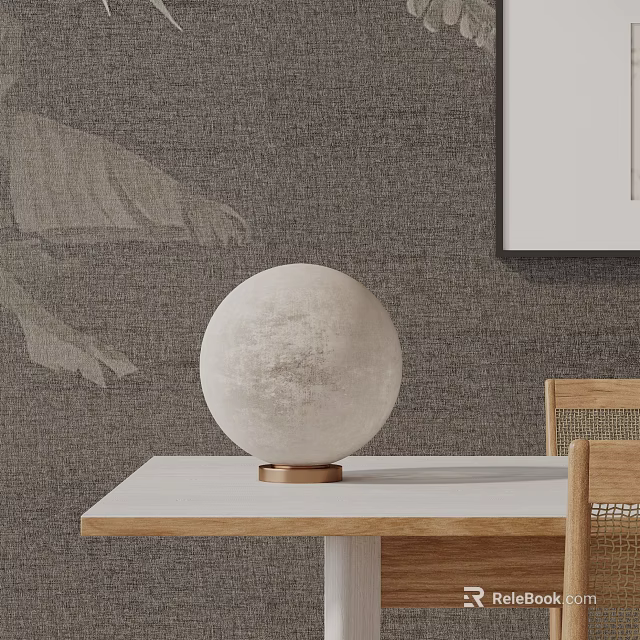 Round Lunar-Textured Table Lamp with Brass Base on Light Wooden Table against Gray Textured Wall 3d model 