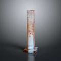 Artistic Stone Sculpture Carving Column Shaped With Red Patterns Square Base On Gray Background