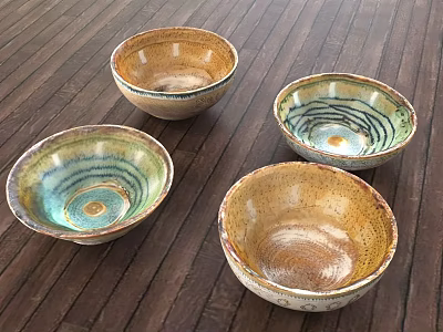 Handcrafted Ceramic Dinnerware Set with Four Colorful Bowls and Spiral Patterns on Wooden Tabletop 3d model