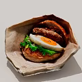 Delicious Hamburger With Sesame Bun Fried Egg And Fresh Lettuce Served In Paper Wrapper