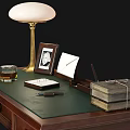 Dark Wooden Desk With Green Top Lamp Photo Frame Notebook Stacked Books And Leather Chair