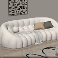 Beige Curved Double Sofa With Petal Shaped Design Cushions Throw Blanket And Geometric Wall Art
