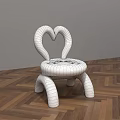 Pink Kids Chair With Heart Shaped Backrest And Rounded Design On Wooden Floor