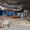 Modern Cafe Interior With Blue Walls Bar Counter White Pendant Lights And Floor Logo