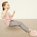 Smiling Red Haired Girl In Striped Shirt Sitting On Light Ground With Raised Fists