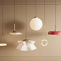 Various Design Pendant Lights Hanging On Beige Framed Wall With Different Shapes