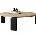 Modern Round Wooden Coffee Table With Black Headphones Stacked Books And Tablet