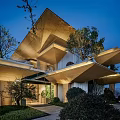 Modern Sales Office Building With Layered Roof Design And Illuminated Exterior Surrounded By Greenery