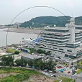Industrial Factory Building With Surrounding Greenery Waterfront Area And Parking Lot
