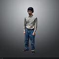 Man in Light Long Sleeve Shirt and Blue Jeans Standing with Headphones Against Gray Background