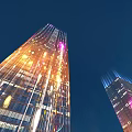 Illuminated Tall Glass Buildings Against Dark Sky Urban Night Landscape View