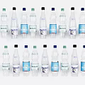 Refreshing Bottled Water In Transparent Bottles With Various Colored Caps And Labels