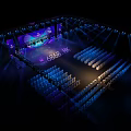 Stunning Stage Design With Blue Lighting Arranged Seats And Backdrop Screens