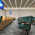 Modern Conference Room With Green Seats Wooden Armrests And World Map Screens