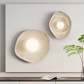 Two Modern Beige Irregular Shape Wall Lamps Illuminated With Green Plant Decor 3d model
