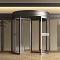 Modern Revolving Door With Metal Frame Glass Panels And Fixed Glass Doors In Indoor Setting